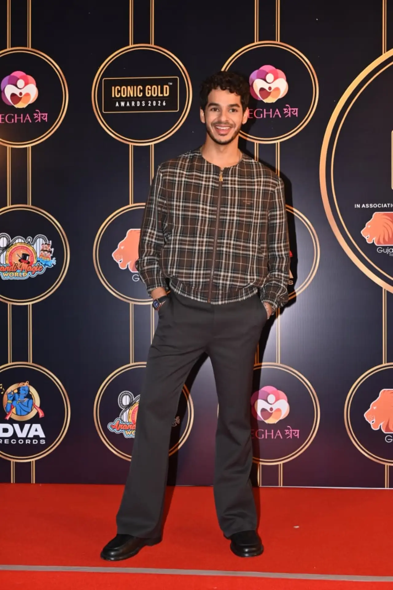 Ishaan Khatter was seen at the red carpet of an event in the city dressed in a checkered shirt and trousers.